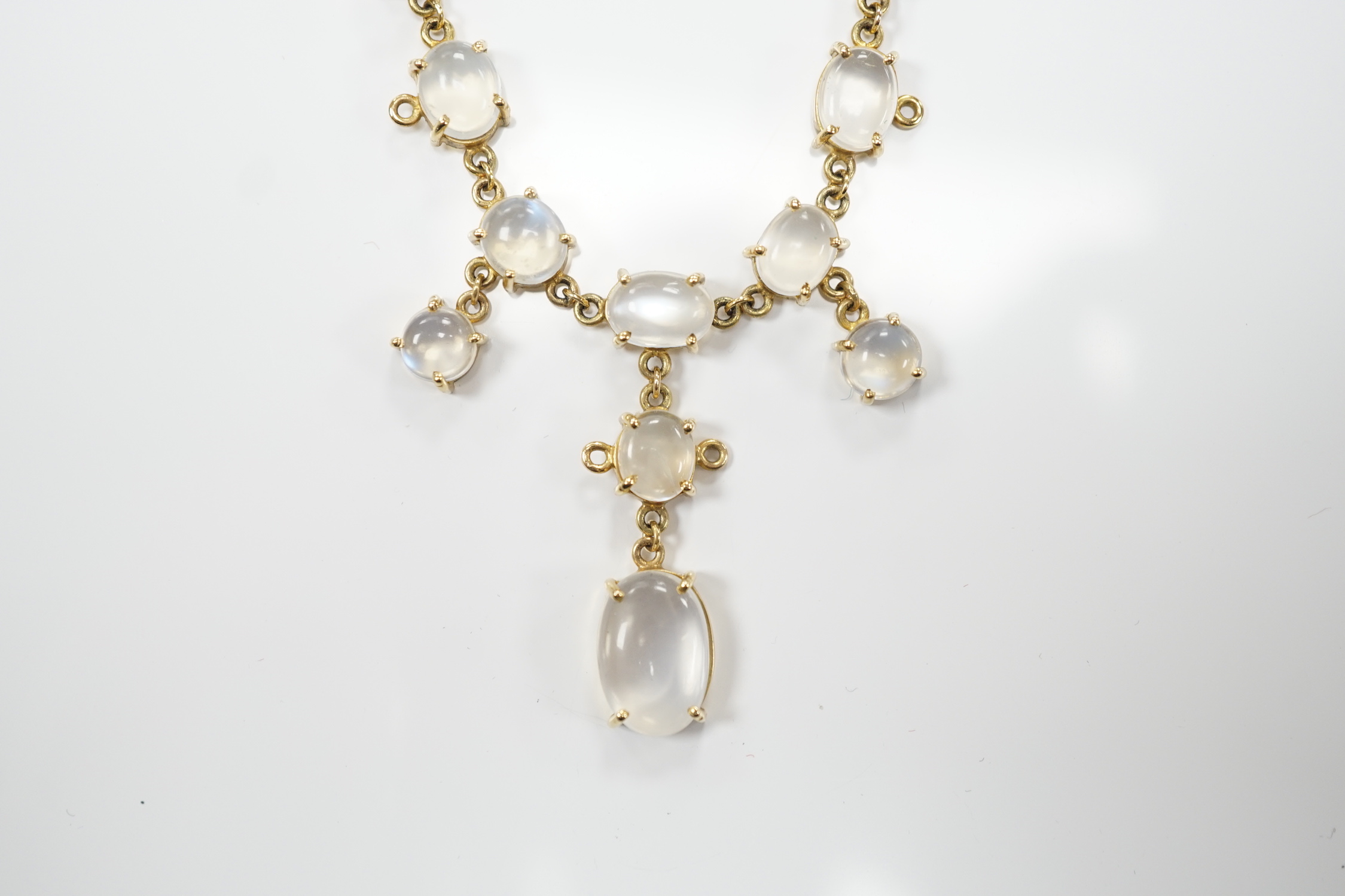 An Edwardian style 9k and cabochon moonstone cluster set drop necklace, 48cm, gross weight 11.2 grams.